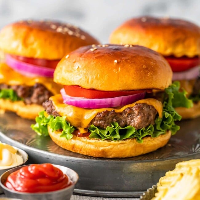 baked burgers and fries served on a metal plate.