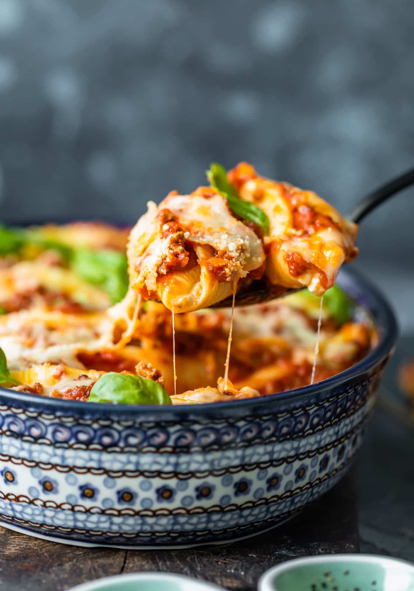 baking dish filled with jumbo pasta shells, cheese, and meat sauce