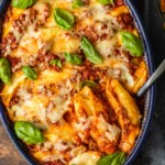 italian stuffed shells in a dish with spoon