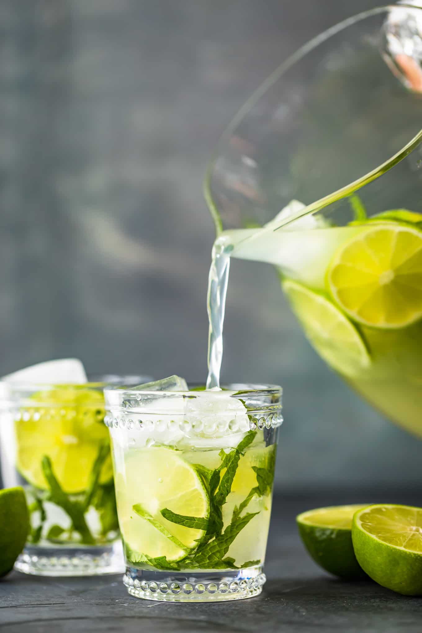 pouring mojitos into glasses