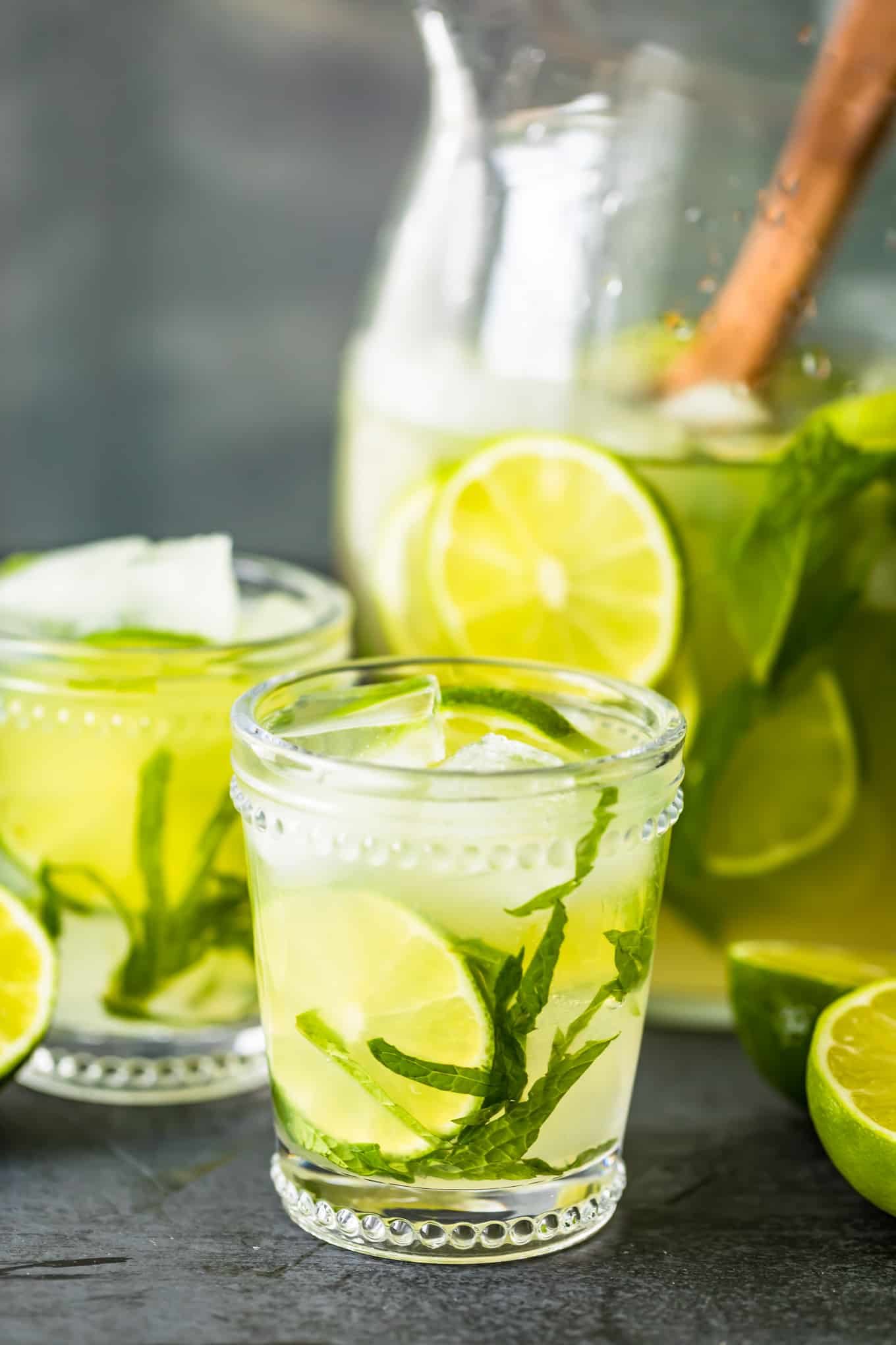 glasses of mojitos next to a pitcher