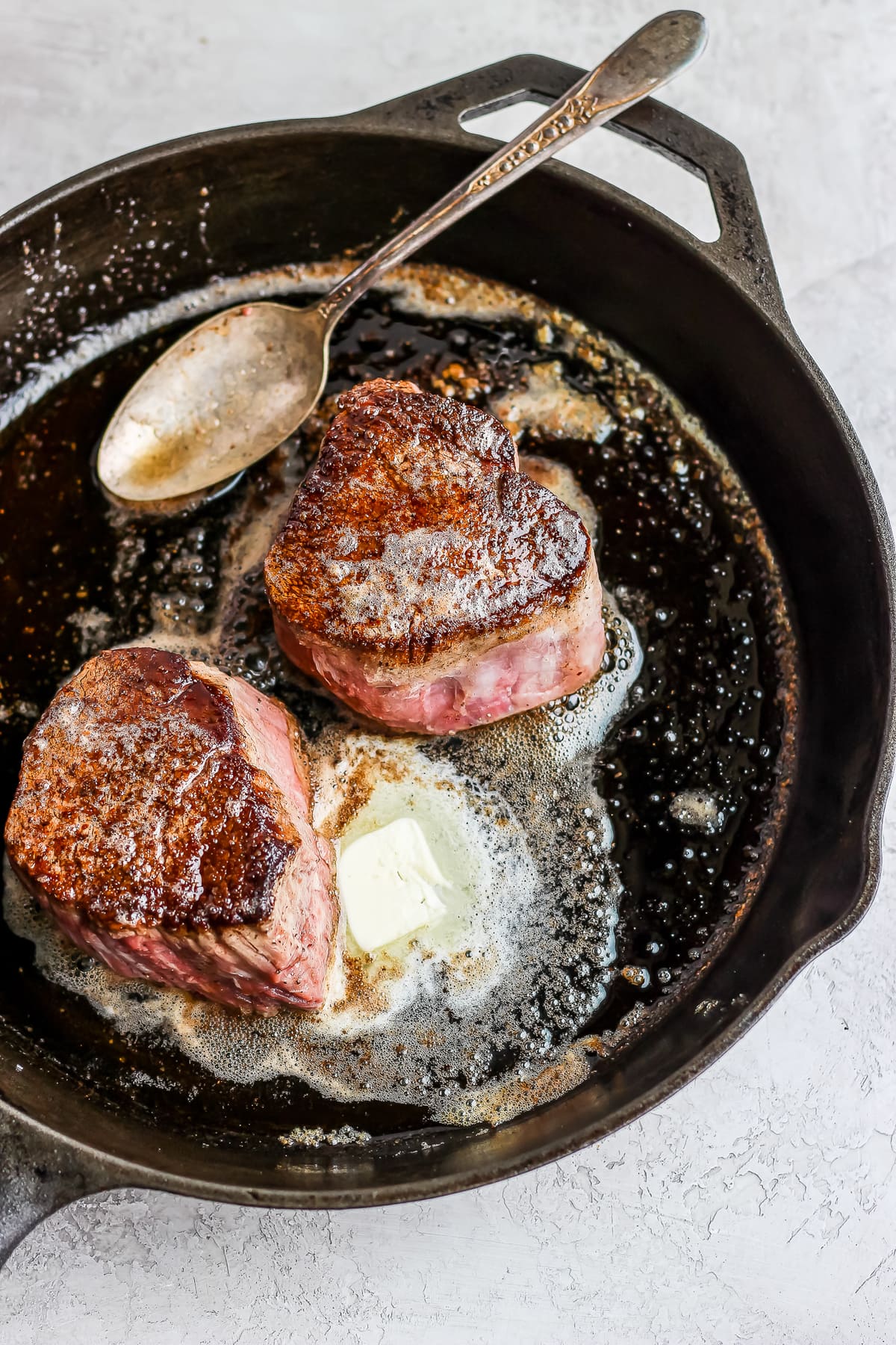 filet mignon cooking in a skillet