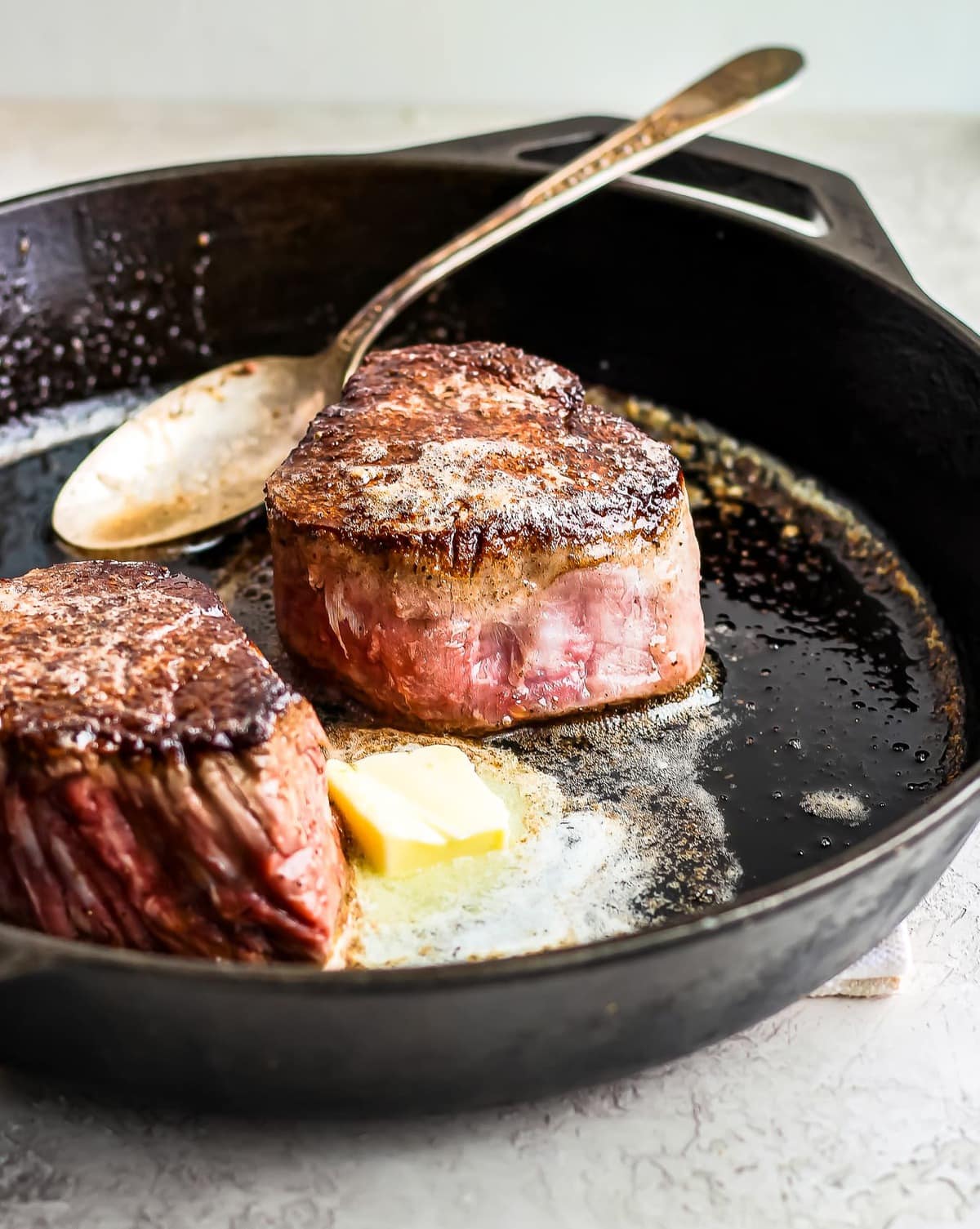 steak and butter in a skillet