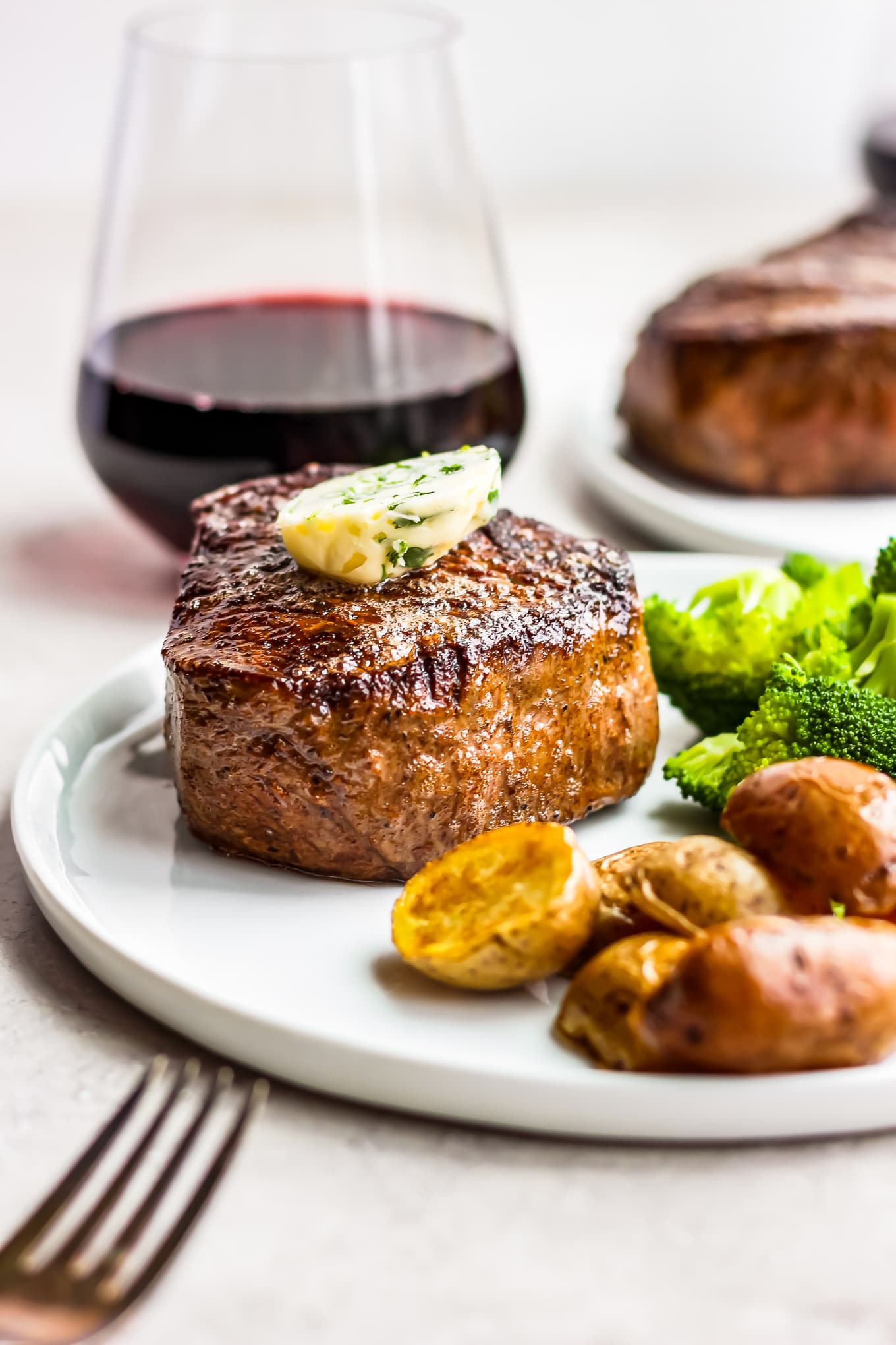 steak dinner with a glass of red wine