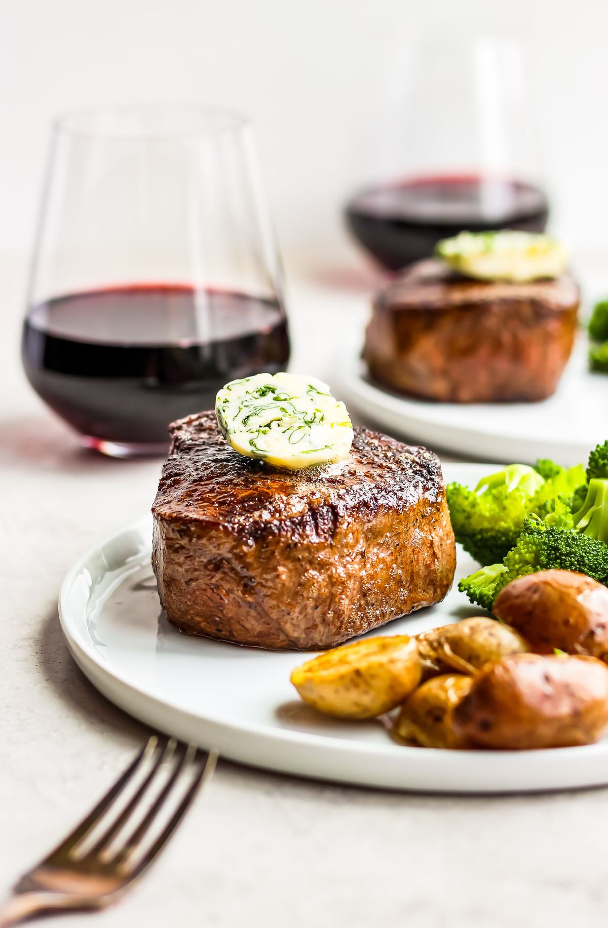 a plate of steak, broccoli, and potatoes