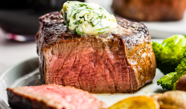 sliced steak with cilantro steak butter on top