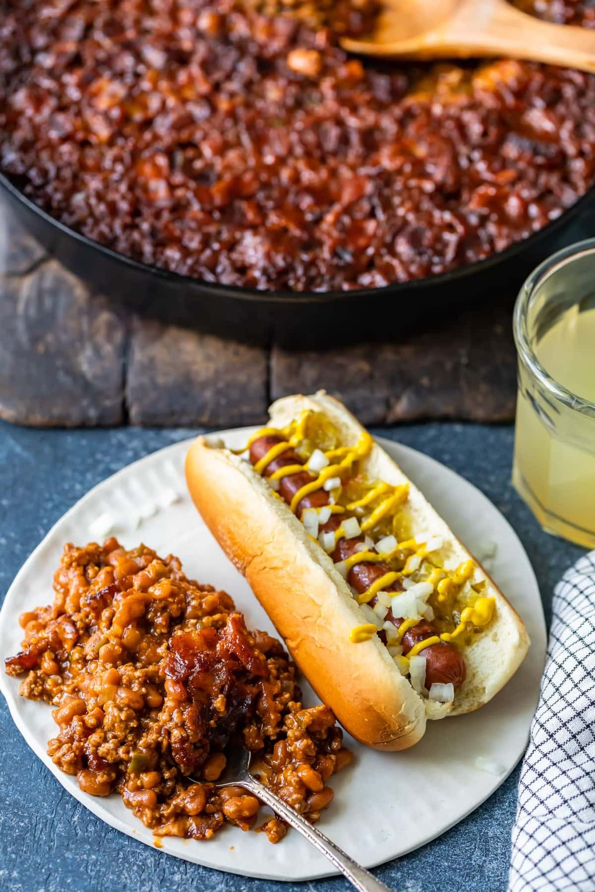 a plate of baked beans and a hot dog