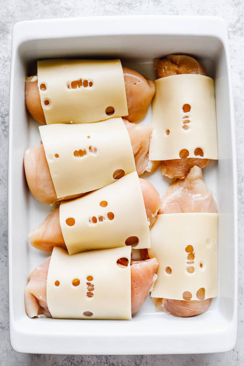 layering Swiss cheese on chicken