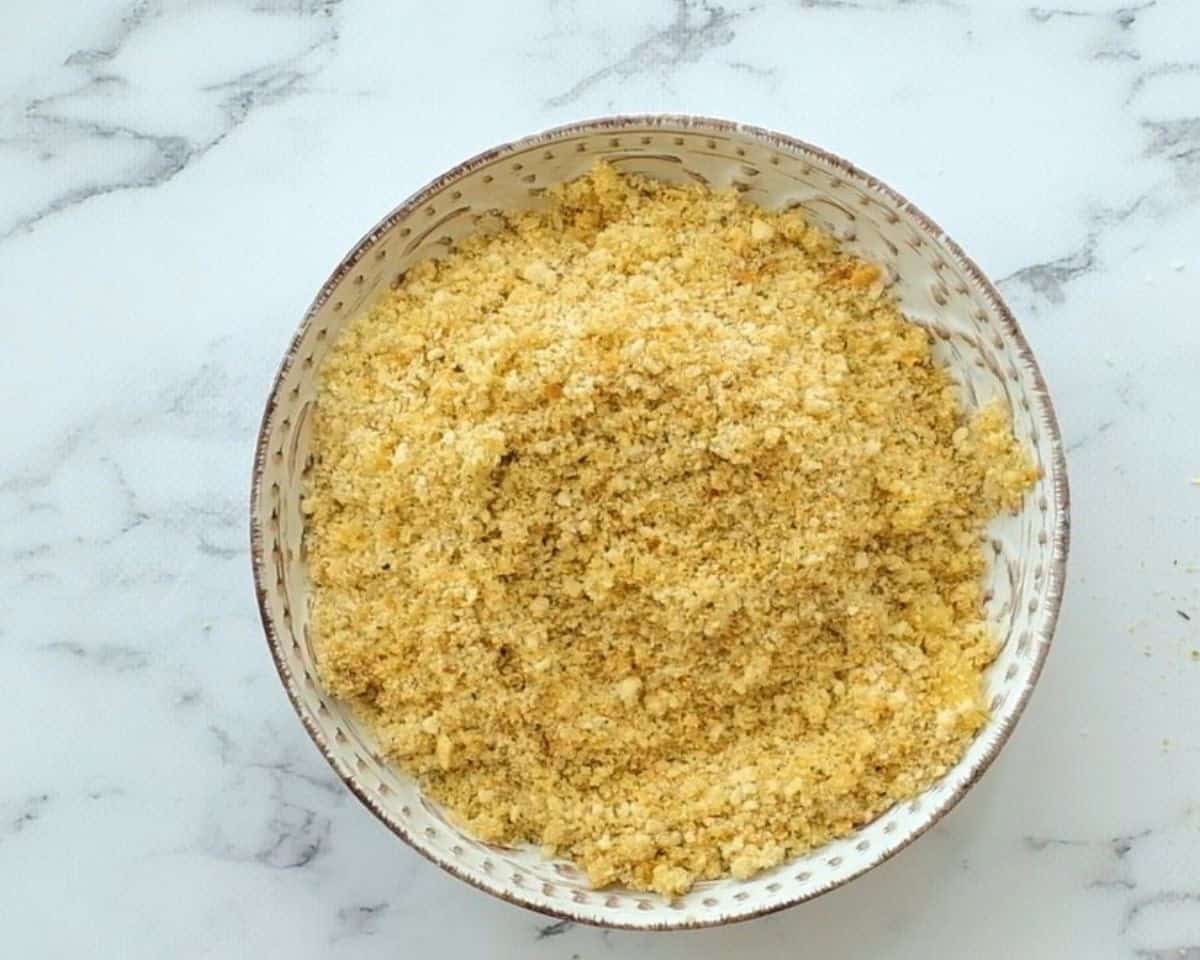 Breadcrumbs in a bowl for coating the mozzarella cheese sticks.