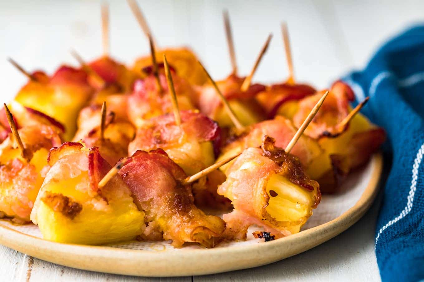 pineapple wrapped in bacon on a serving plate