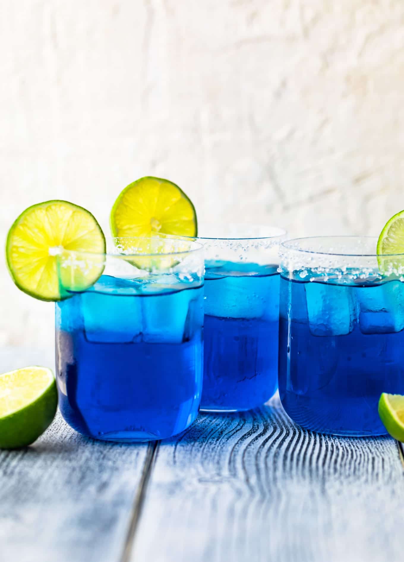 three glasses of blue margaritas