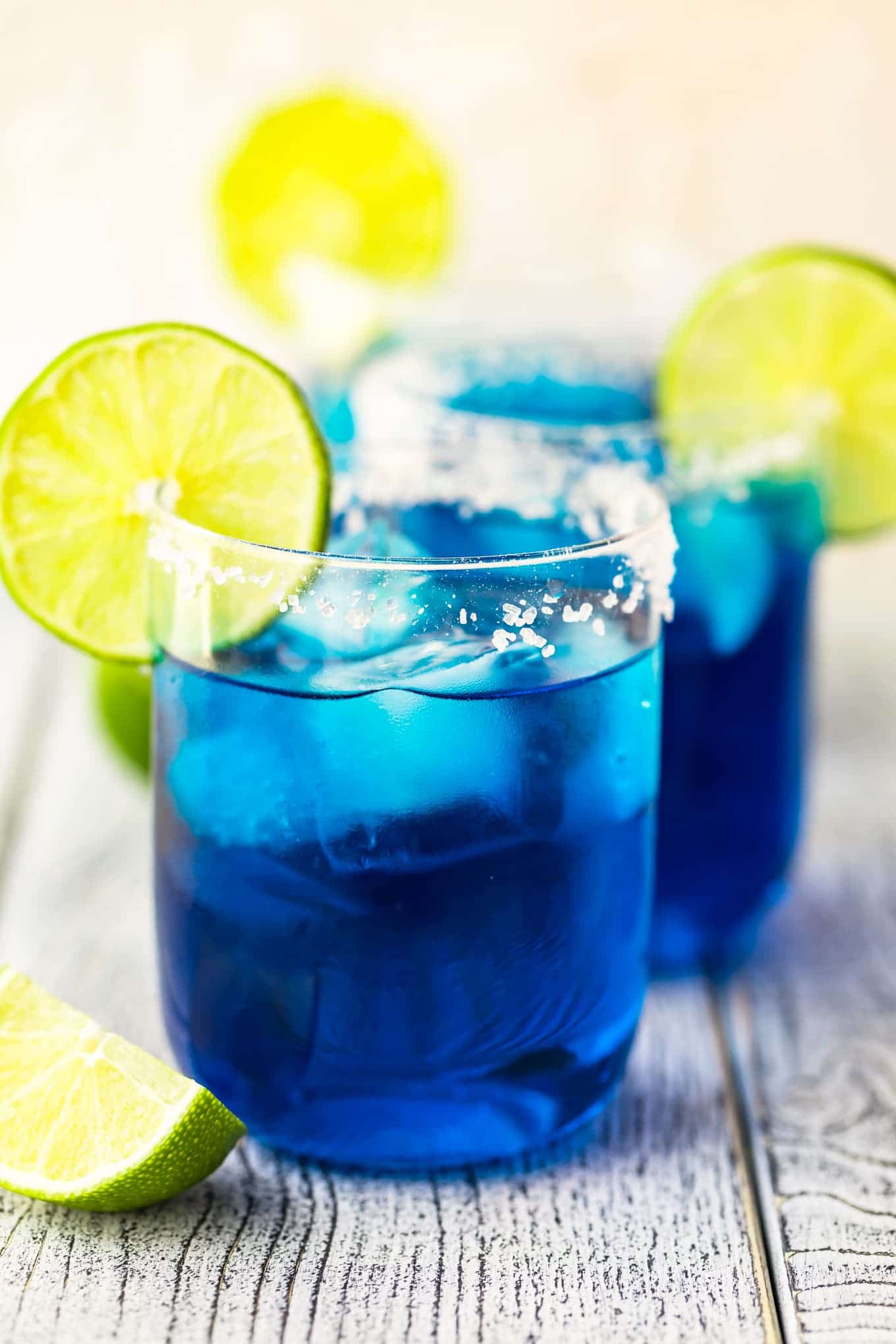 A blue margarita garnished with a lime slice