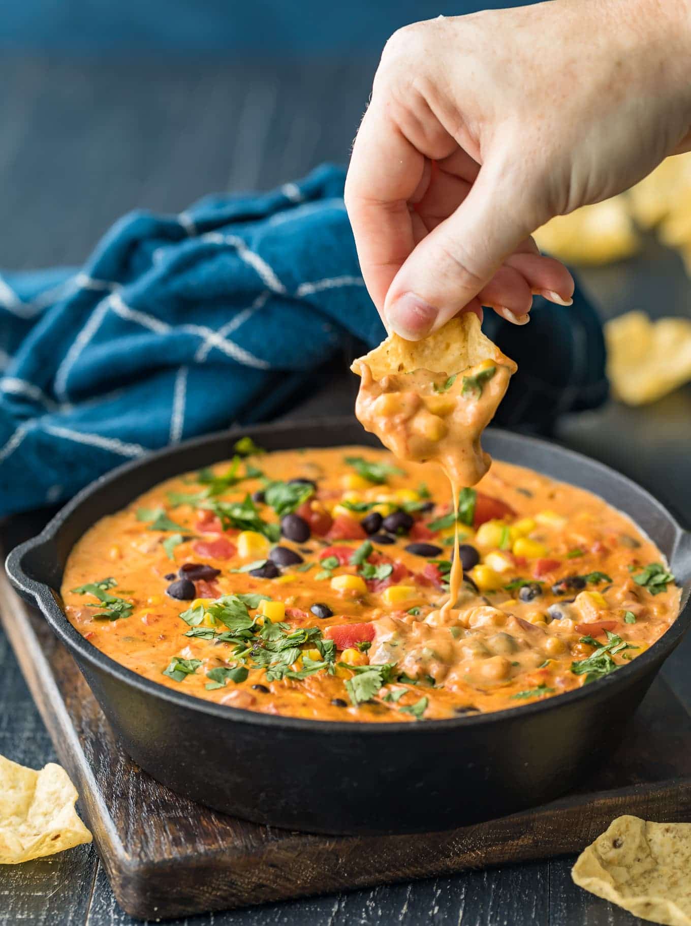The cheese dip dripping from a tortilla chip