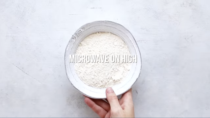 a bowl of flour with the text "microwave on high".