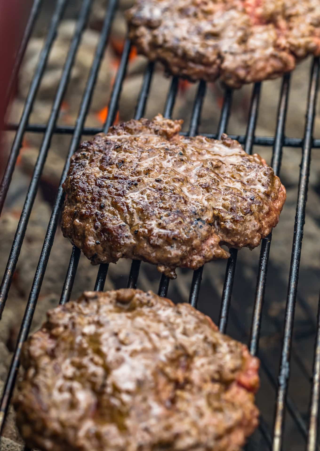 Three cooked burger patties on a grill