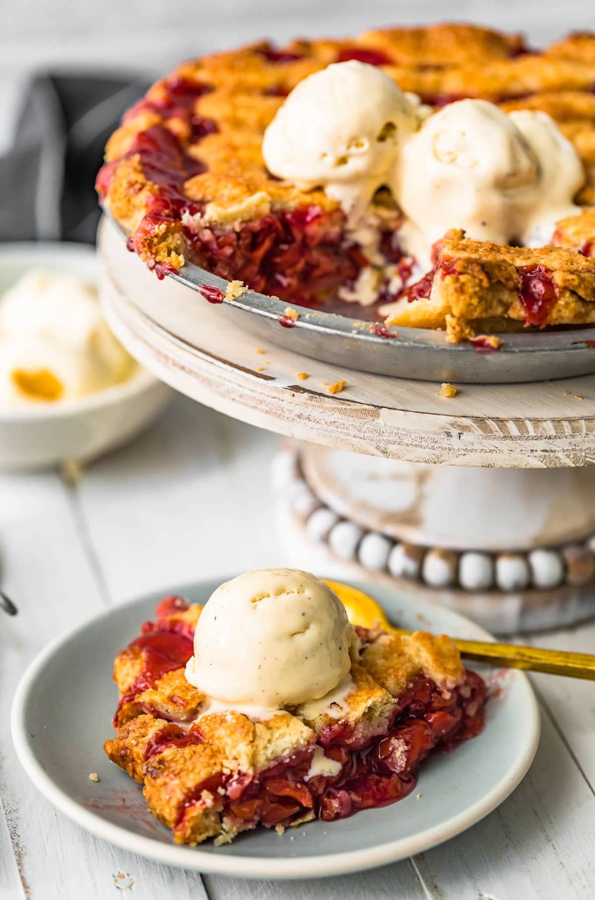 A slice of pie on a plate with ice cream