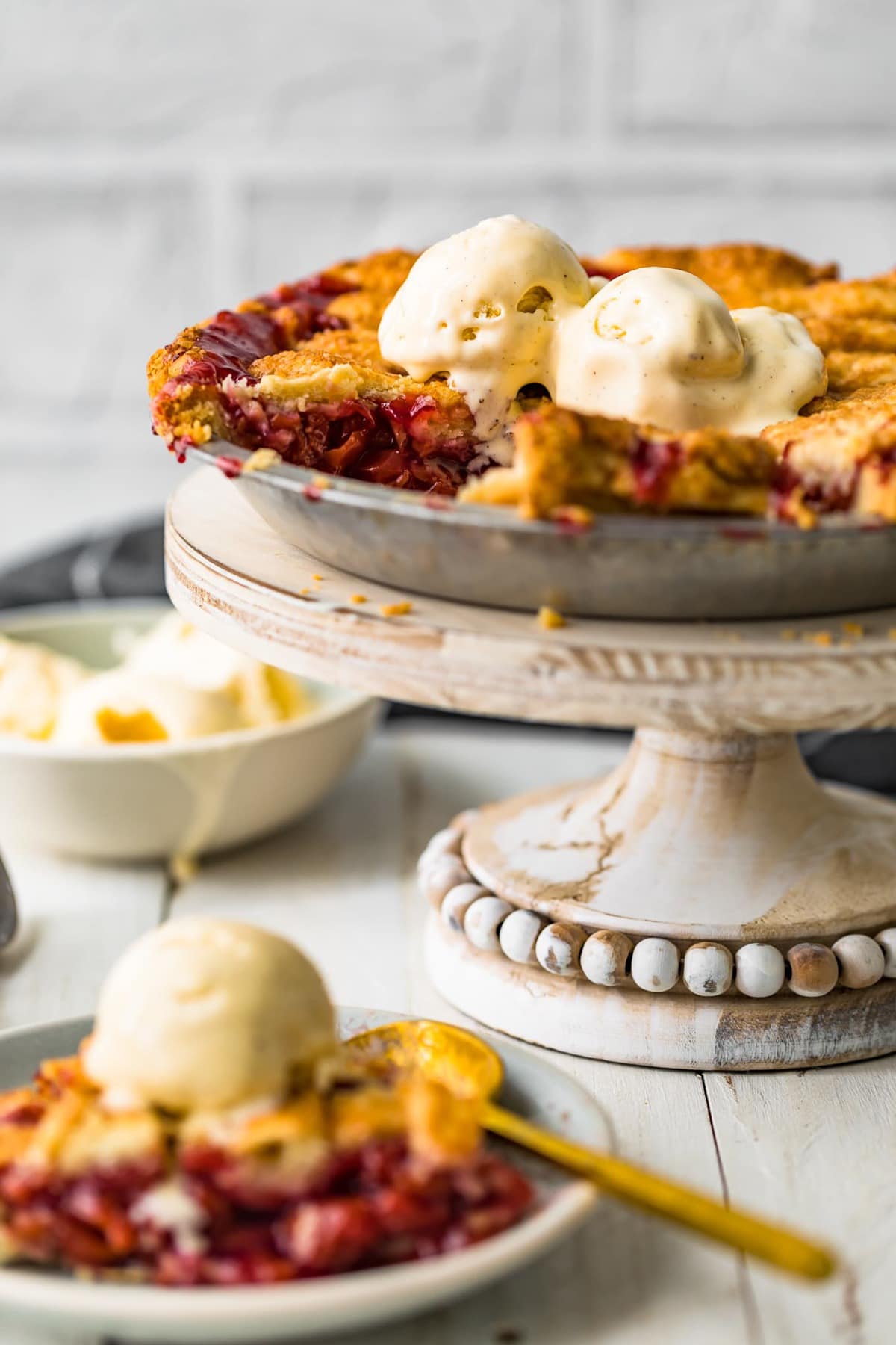 Homemade cherry pie in a pan on a cake stand