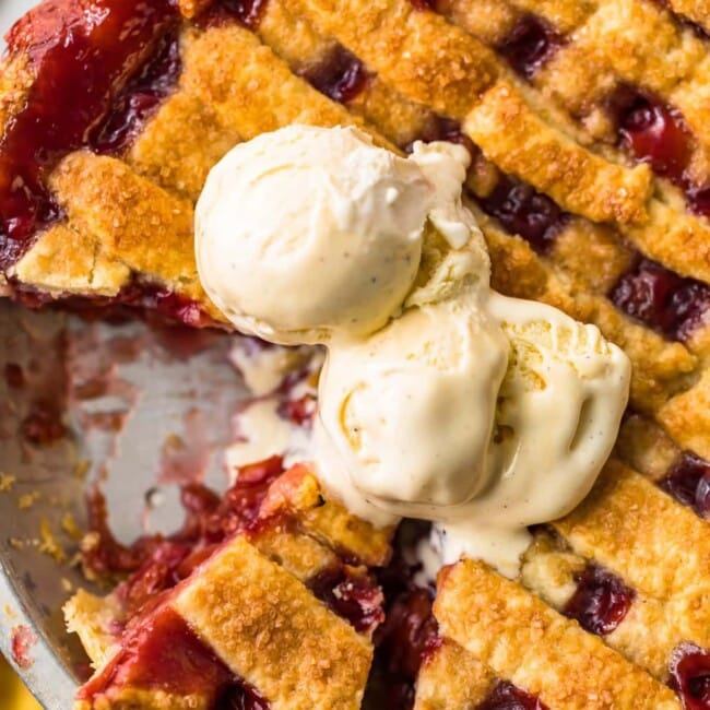 a homemade cherry pie with a scoop of ice cream on top.