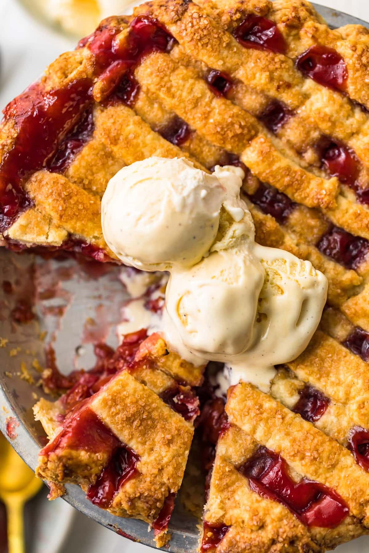 Top shot of homemade cherry pie with a slice cut out of it