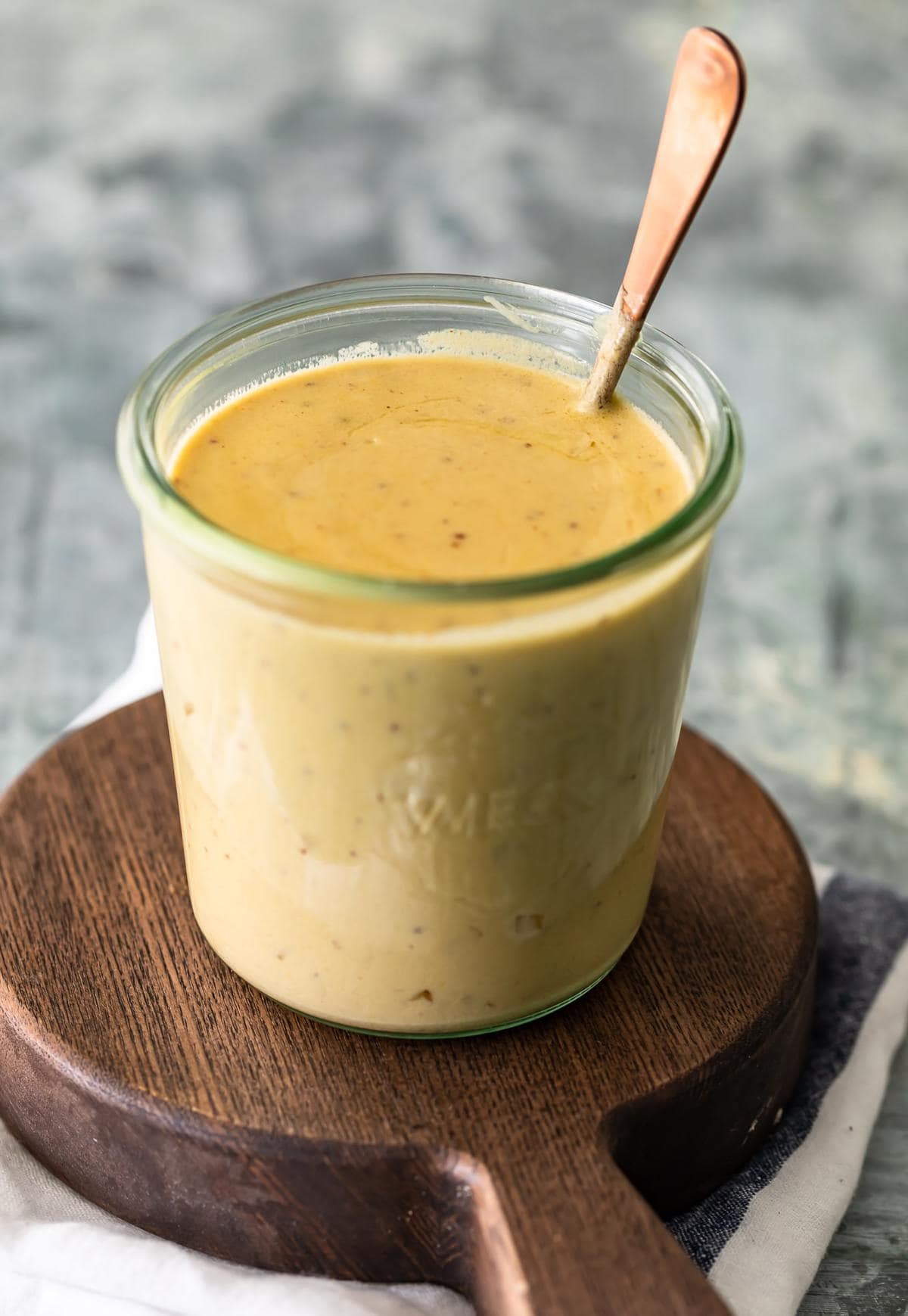 A yellow creamy sauce in a jar on a work surface