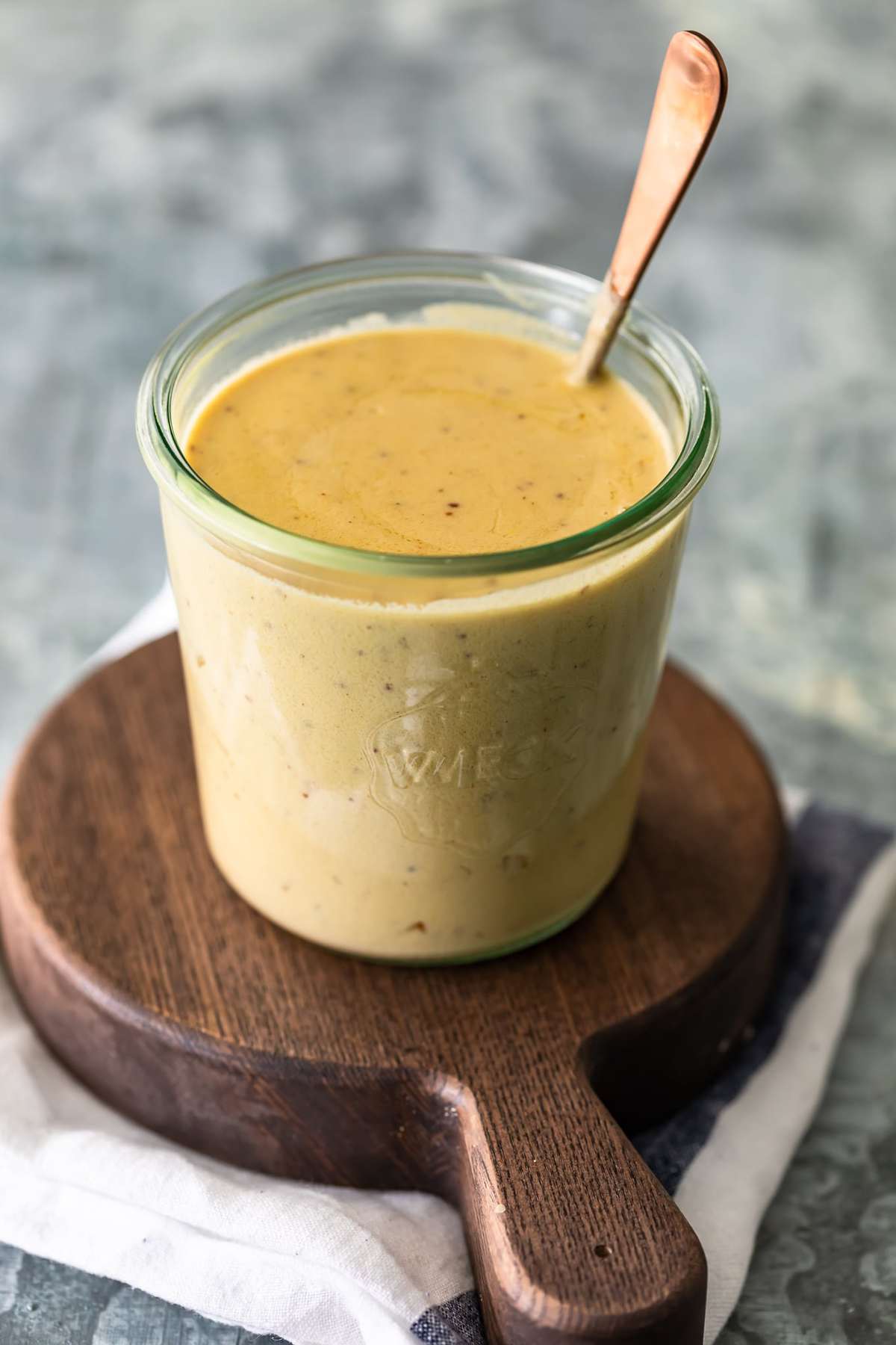 Yellow sauce in a jar with a spoon