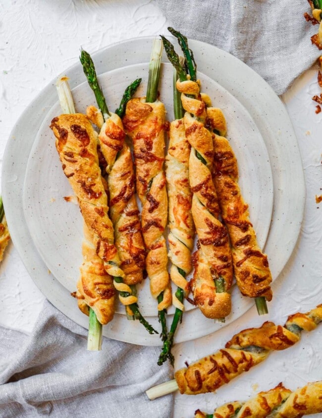 asparagus wrapped in puff pastry on white plate