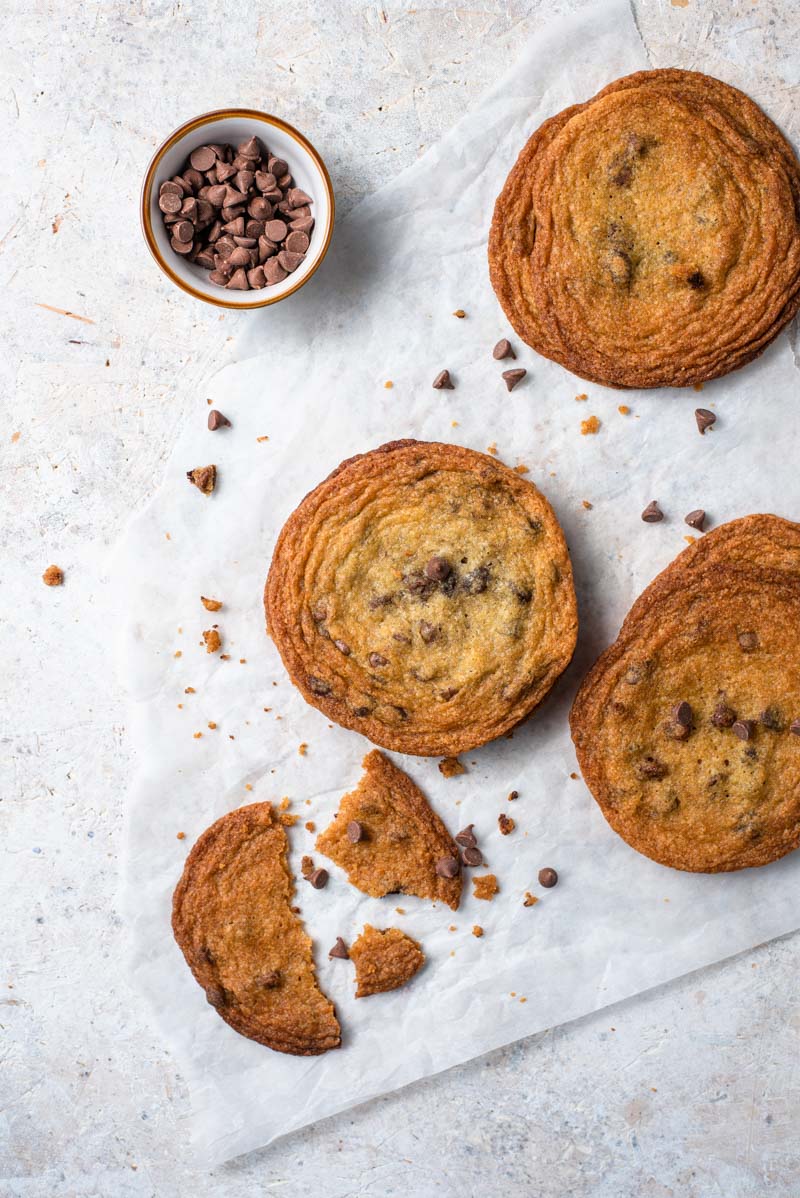 Brown Sugar Cookies with Chocolate Chips are made with light brown sugar, butter, and chocolate chips. They're super easy to make and without a doubt are my favorite cookie ever. An overhead shot of Brown Sugar Cookies with Chocolate Chips on parchment paper.