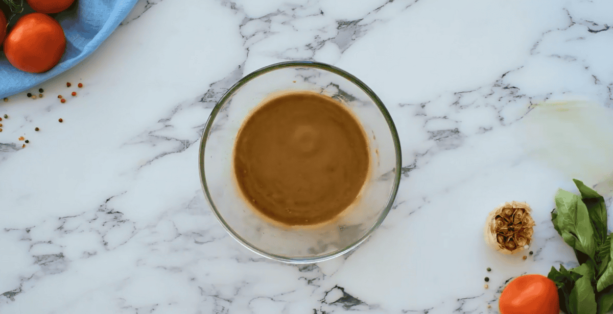 Balsamic vinegar and yogurt mixture in a glass bowl. 