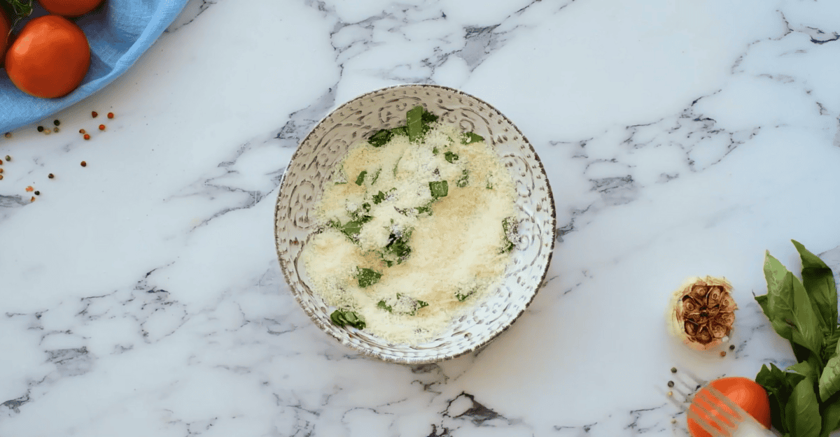 Parmesan cheese and fresh basil mixture in a bowl. 