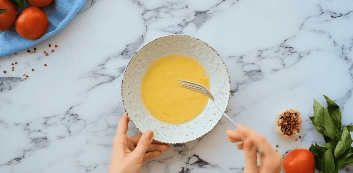 Egg mixture in a white bowl.