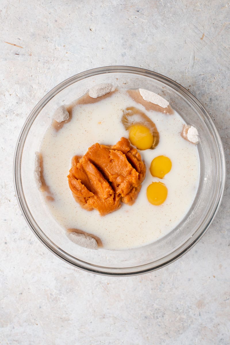 It wouldn't be Fall without a Homemade Pumpkin Pie and this pie is without a doubt the best I've ever tasted and is super easy to whip up! #pumpkinpie #dessert Ingredients in a bowl to make homemade Pumpkin Pie.