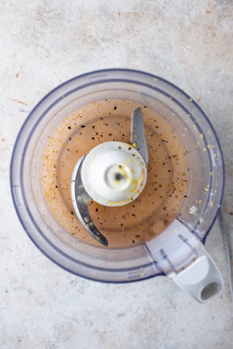 Ingredients in a food processor for making a lemon vinaigrette