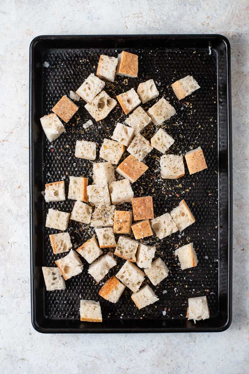 Cubed bread on a baking tray for making panzanella salad