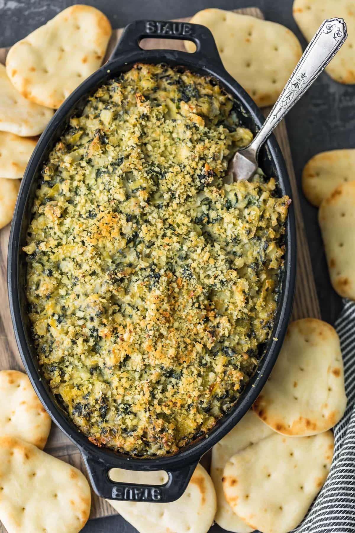 Top shot of Baked Spinach Artichoke Dip in a black dish