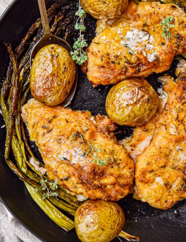 baked chicken and potatoes in skillet