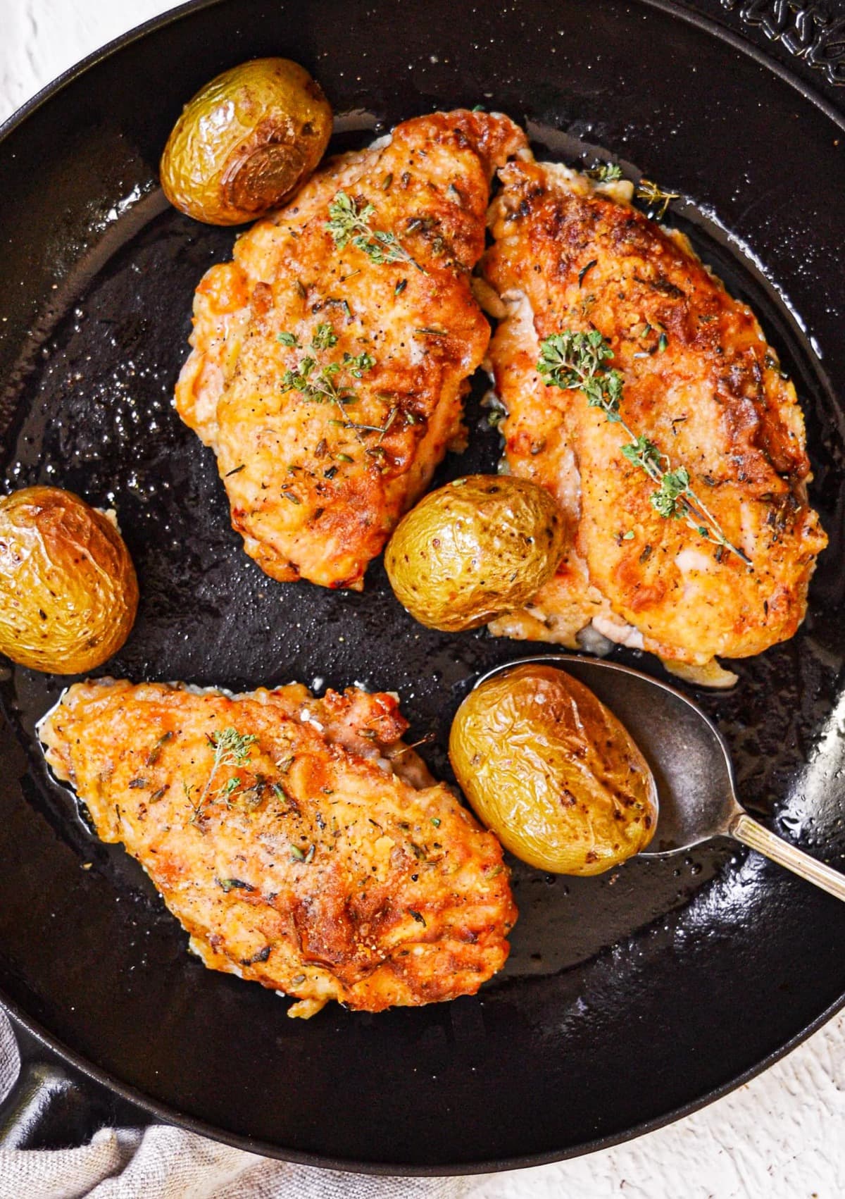 chicken breasts with baby potatoes in a dish