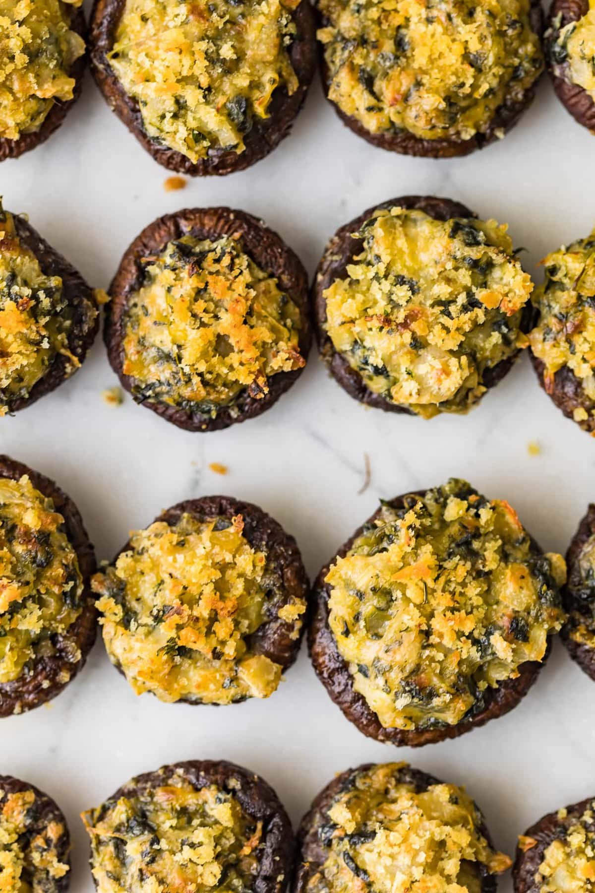 Top shot of Spinach Stuffed Mushrooms on a marble surface