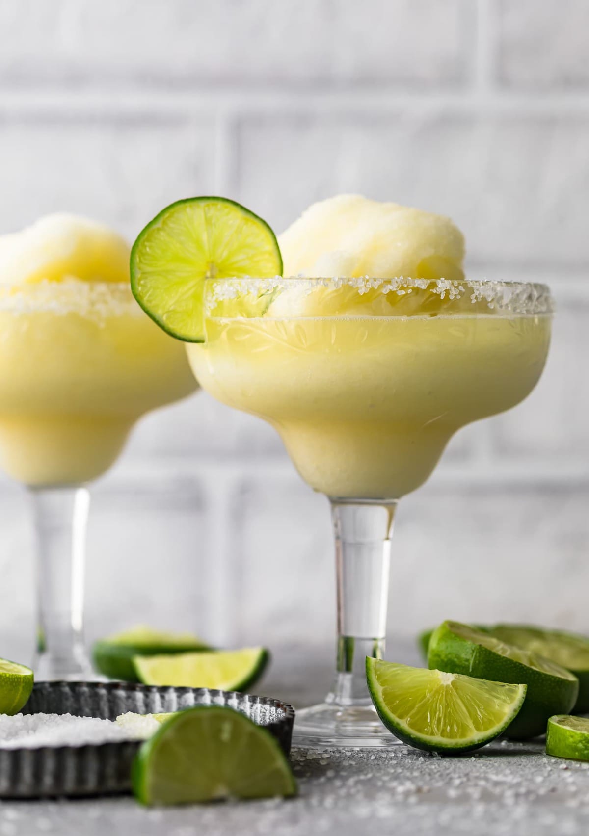 Two frozen margaritas served in glasses