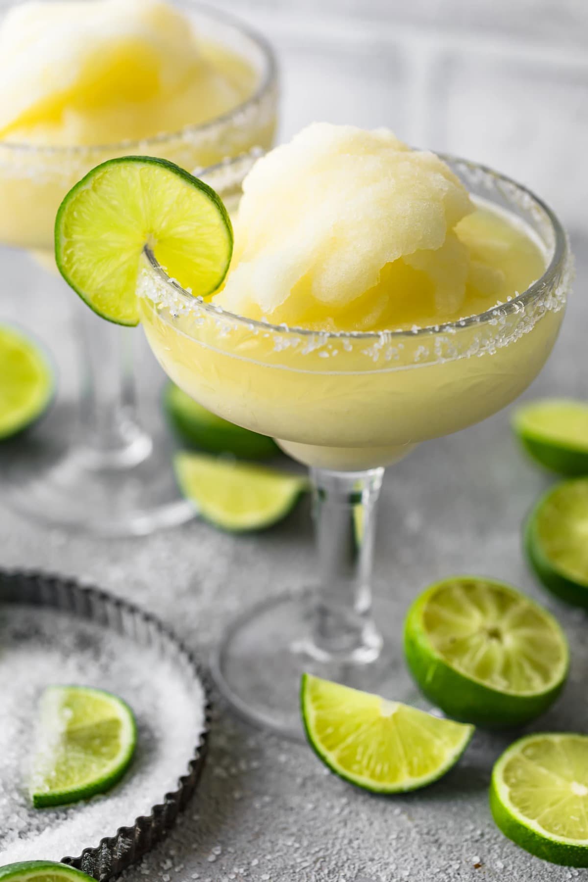 A frozen margarita served with a slice of lime