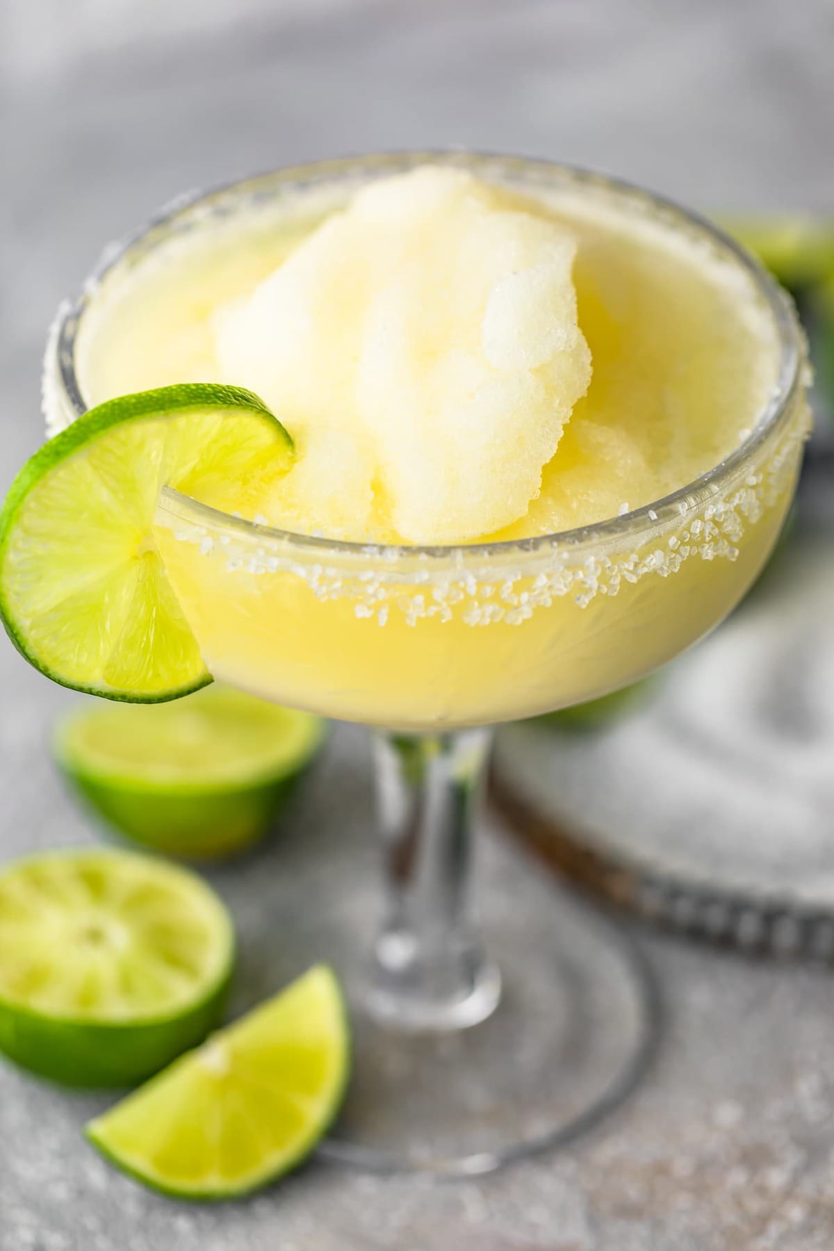 A margarita served in a glass with lime and salt