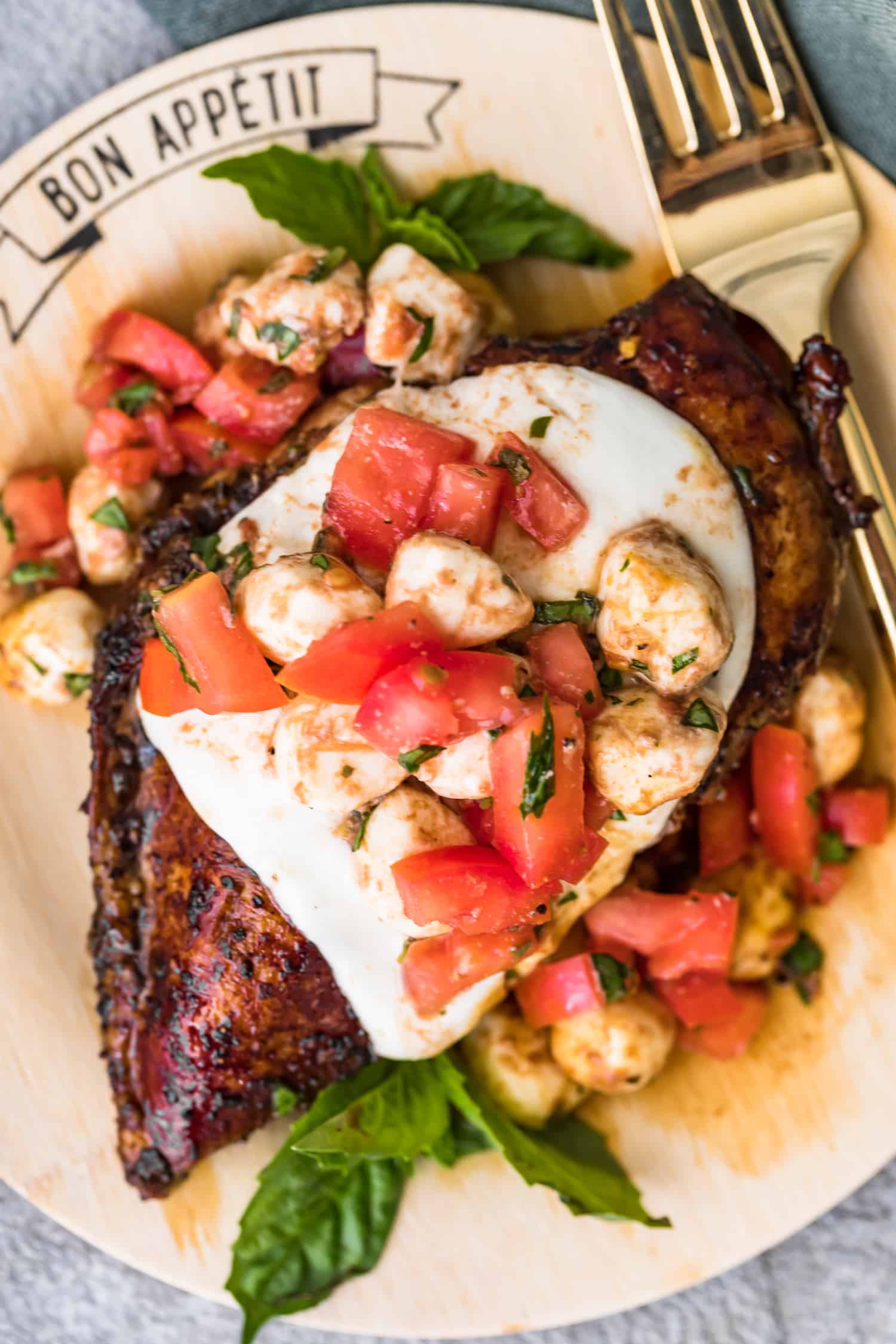 close up shot of mozzarella and tomatoes on chicken