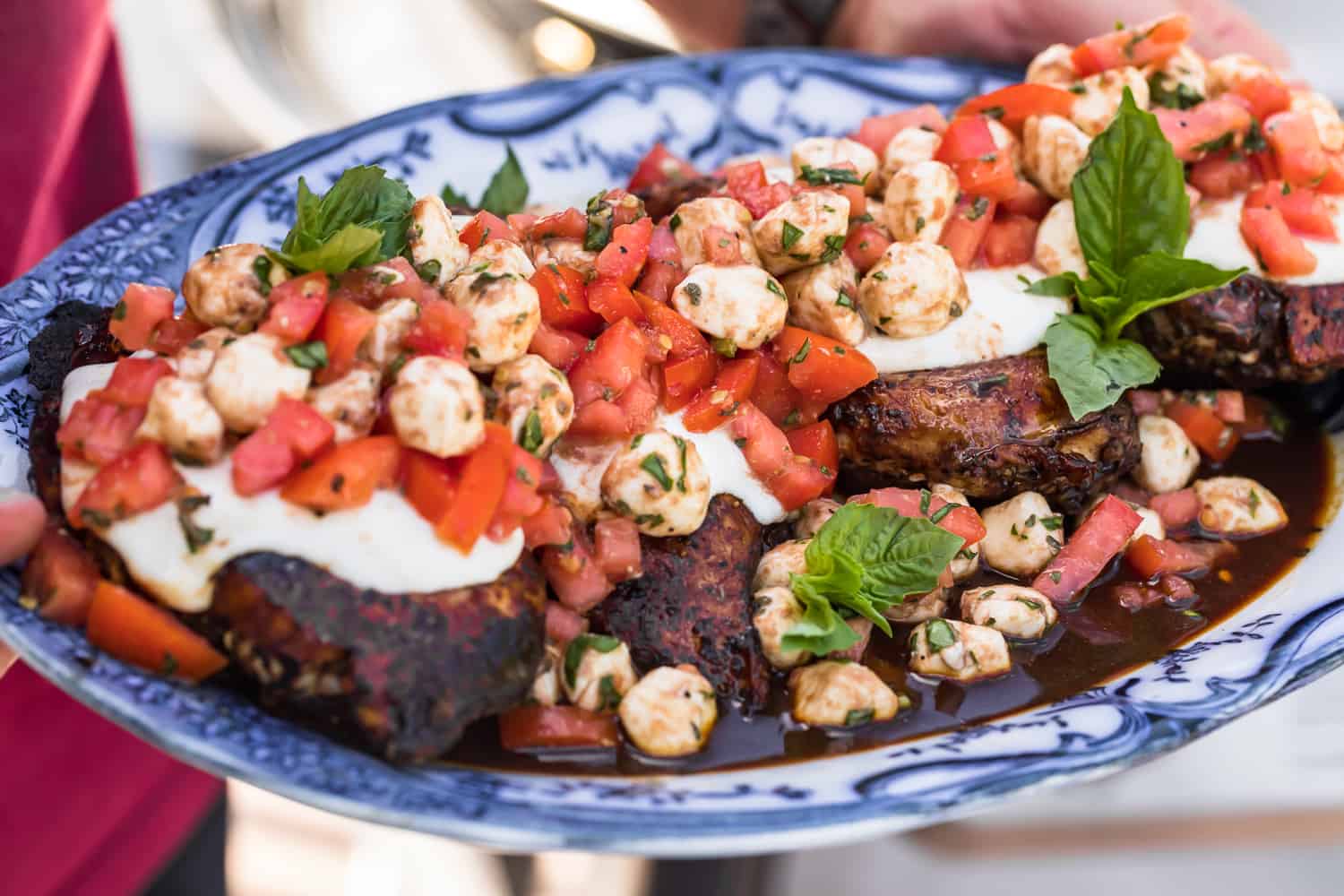 grilled bruschetta caprese chicken on a platter