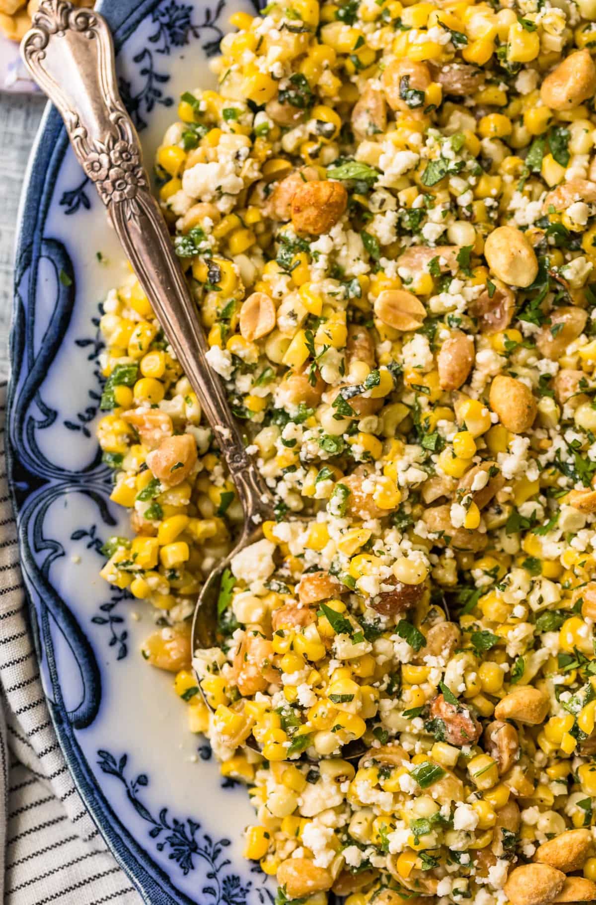 Close up of grilled corn salad on a blue and white plate