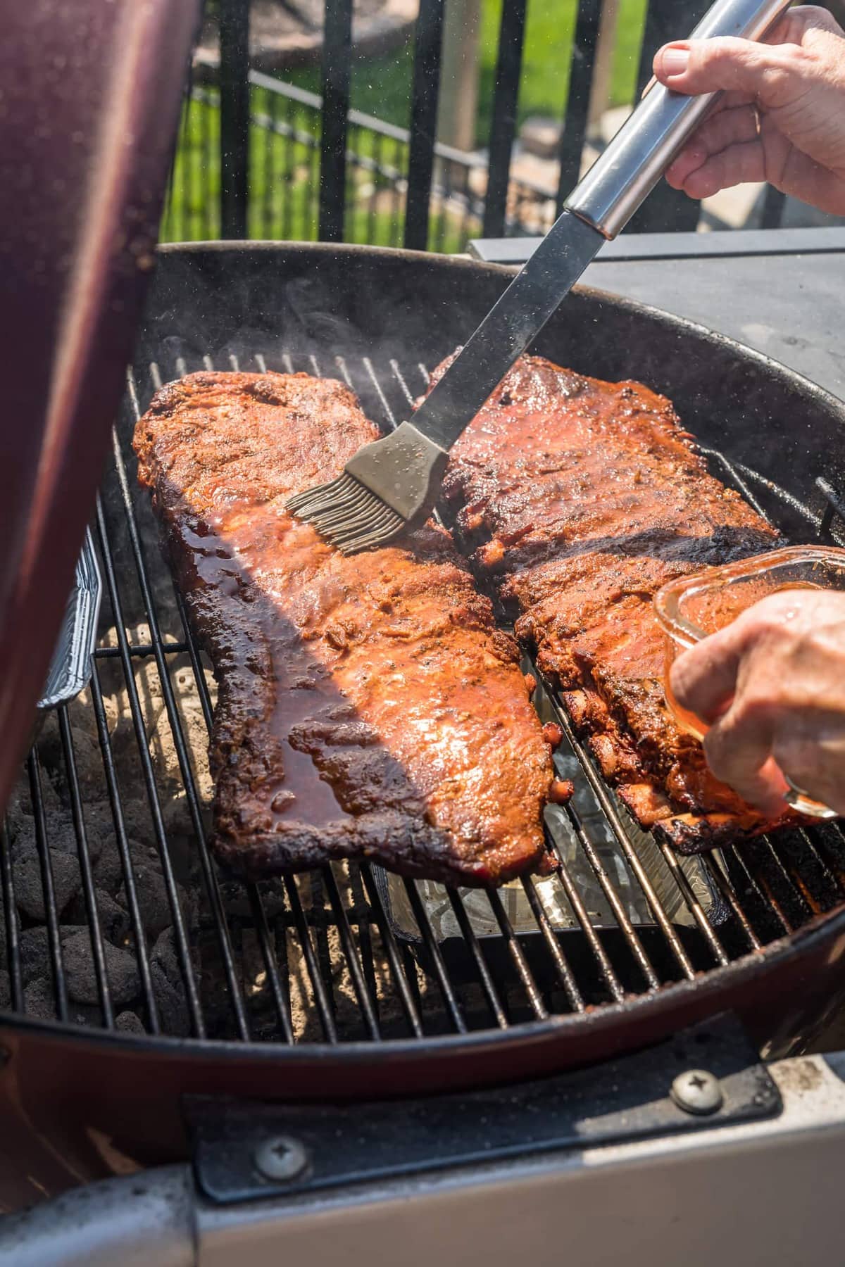 St.Louis Ribs being mopped on a grill