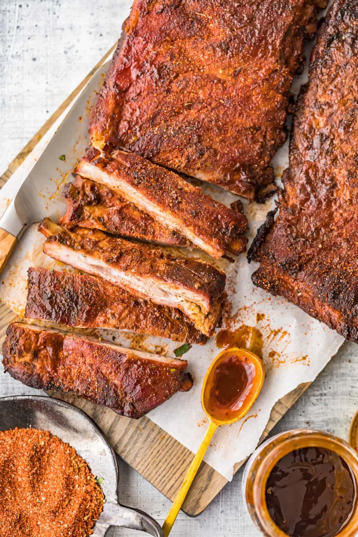 overhead view of grilled ribs, one rack is cut