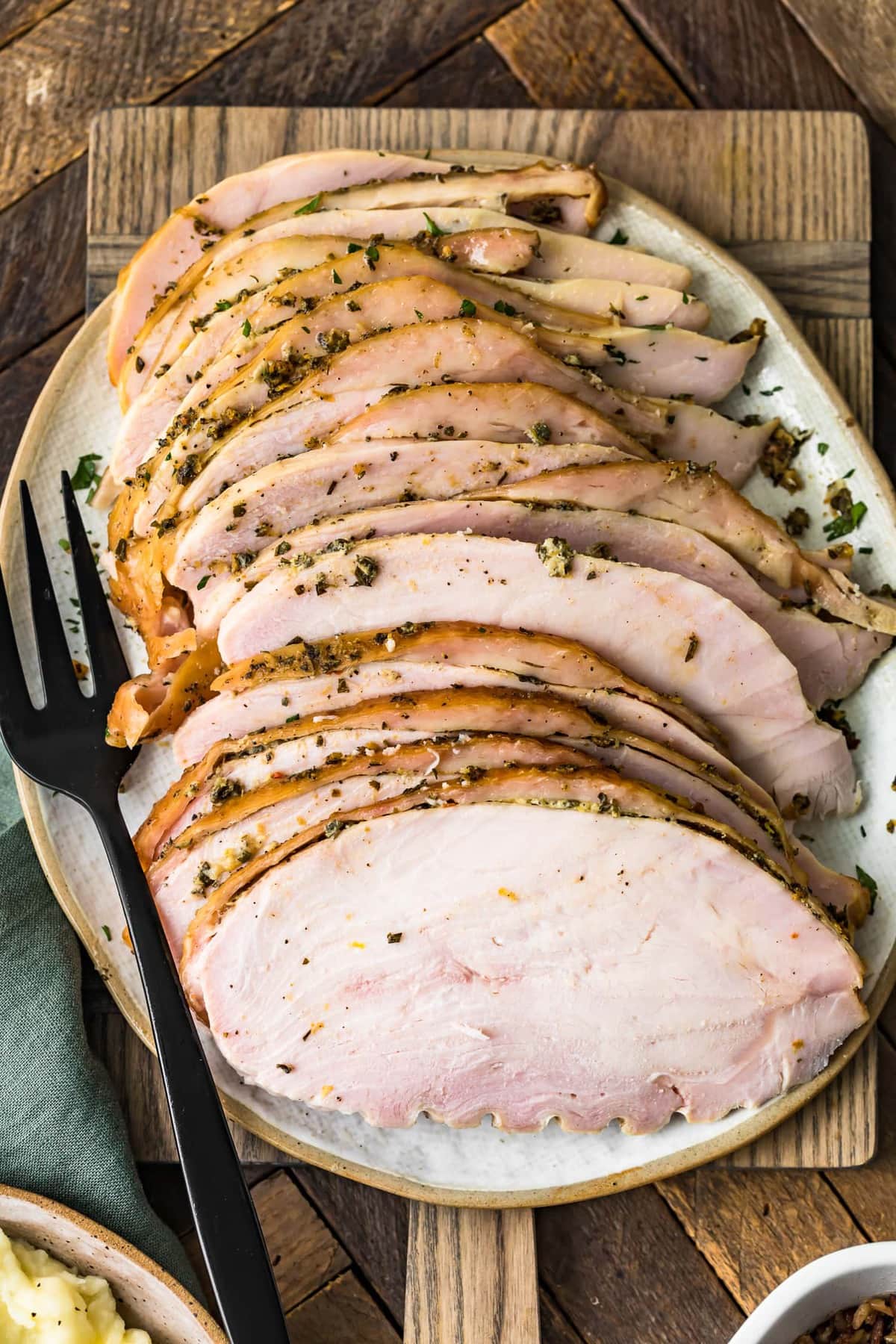 juicy smoked sliced turkey breast on a cutting board