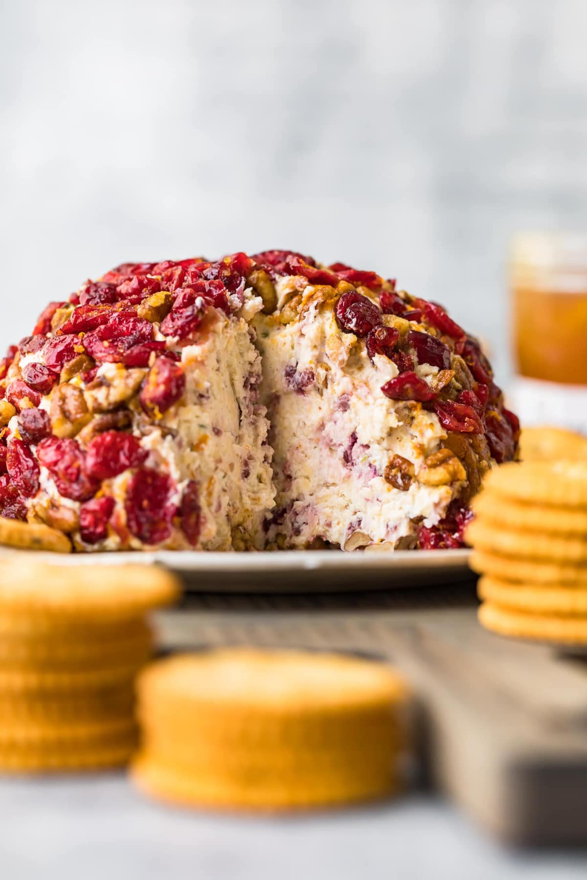 A Christmas cheeseball with a section cut out of it