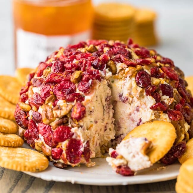 Christmas cranberry cheese ball with crackers and honey.