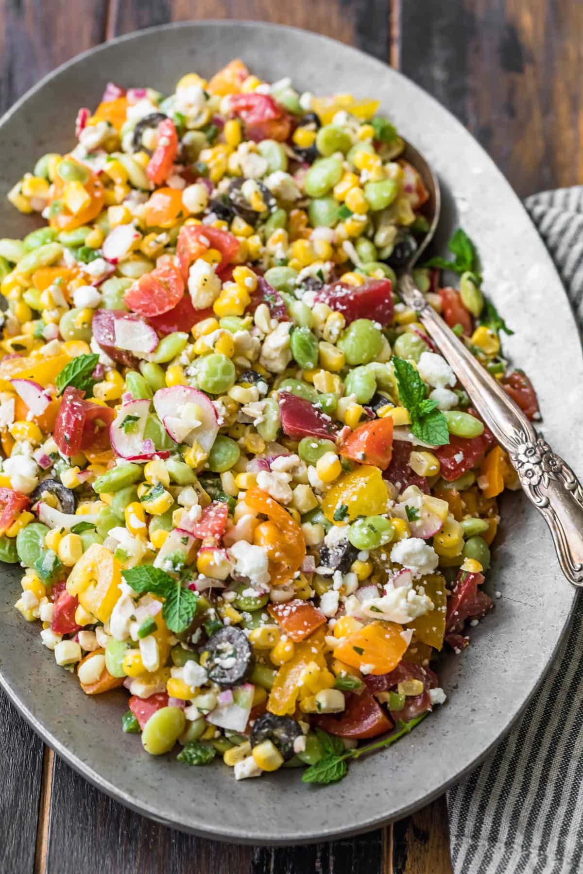 Chopped salad on a plate with a serving spoon