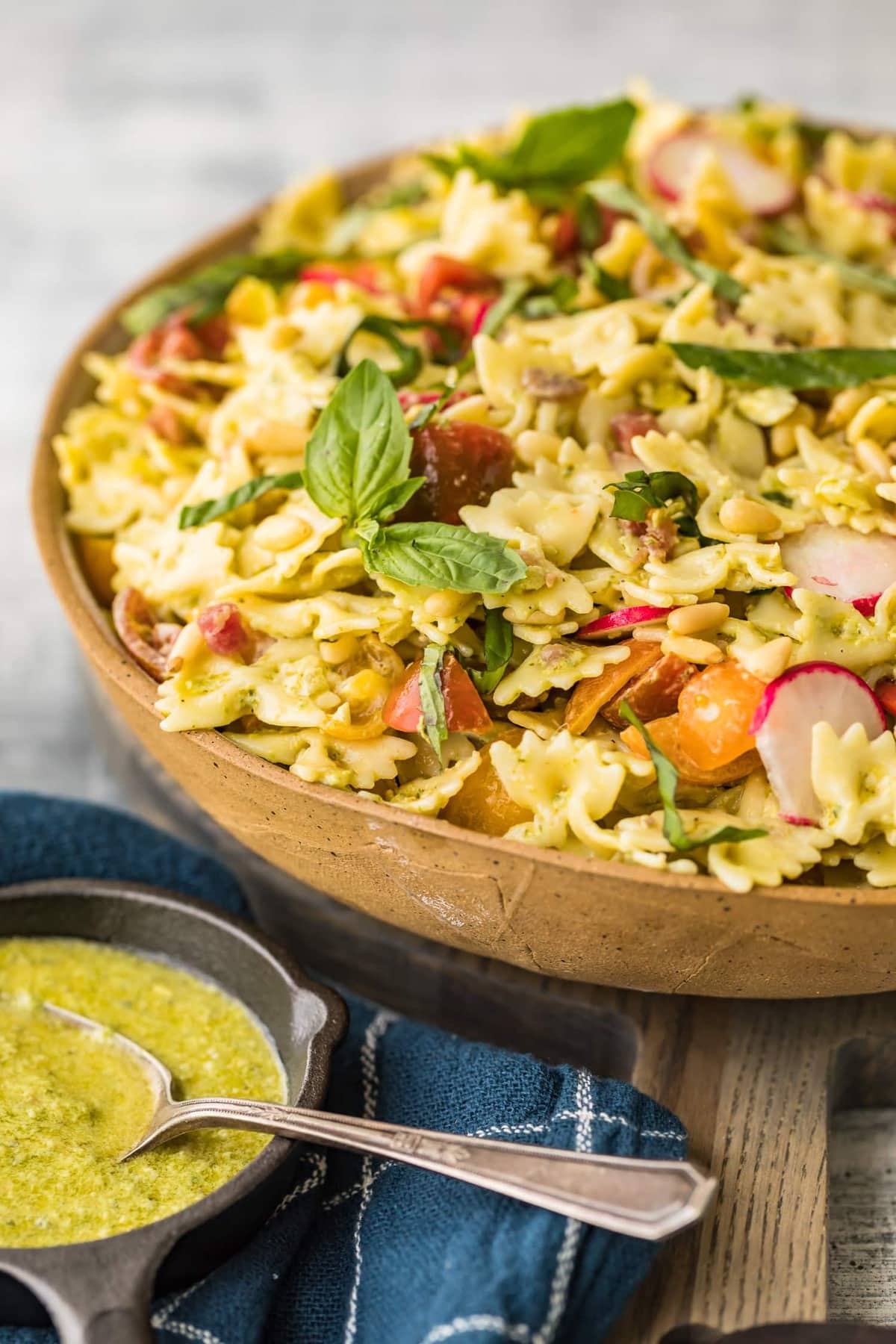 Pesto pasta salad served in a large bowl